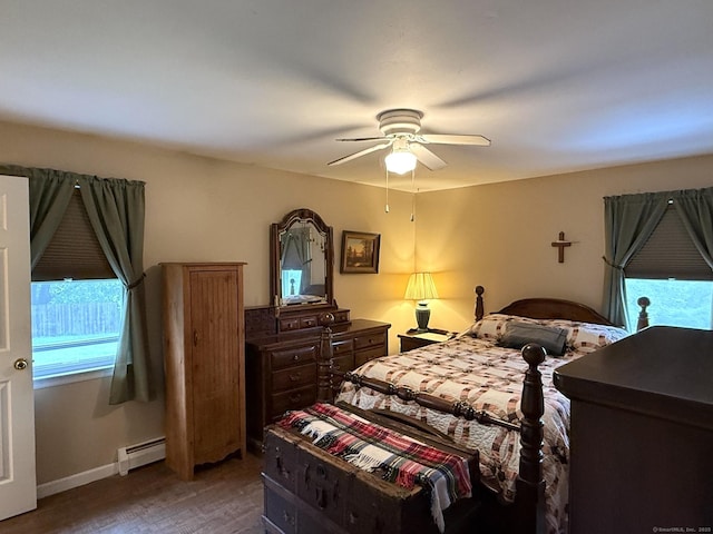 bedroom with baseboard heating, light wood-style flooring, ceiling fan, and baseboards