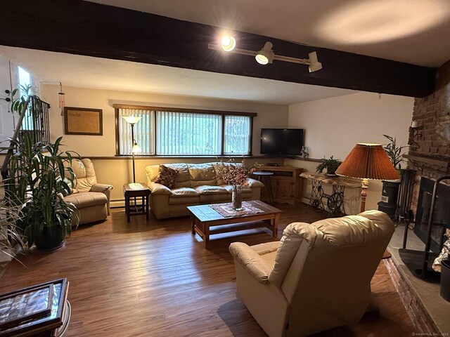 living area with wood finished floors, baseboard heating, and a fireplace