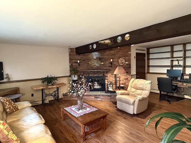 living room featuring wood finished floors, a brick fireplace, and an office area