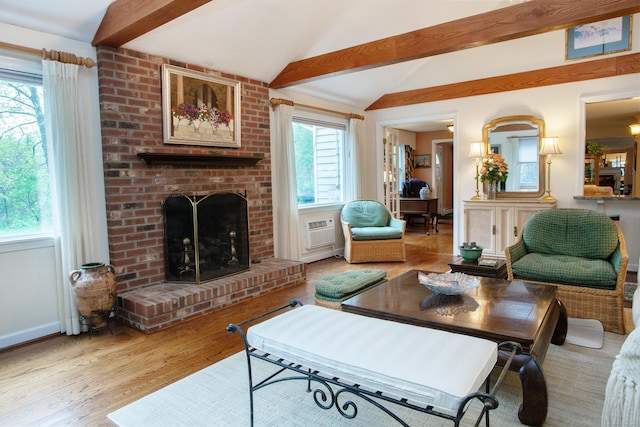 living area with light wood-style flooring, a brick fireplace, and an AC wall unit