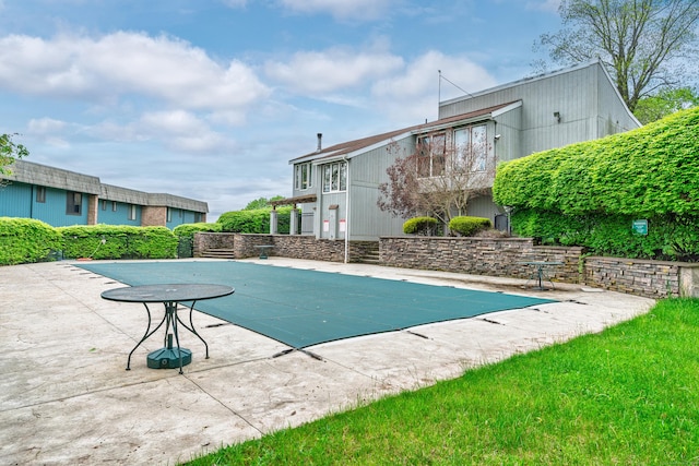 view of swimming pool with a patio area and a covered pool