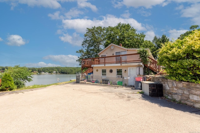 44 Laurel Point Dr, Montville, CT 06370 - view of front facade featuring stairway, a gate, a deck with water view, and central air condition unit