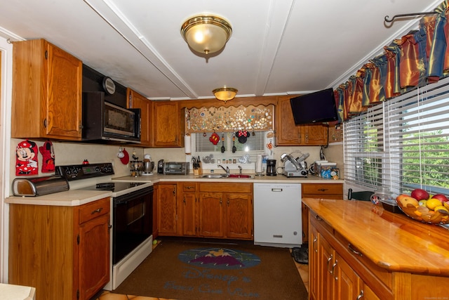 44 Laurel Point Dr, Montville, CT 06370 - kitchen featuring white dishwasher, electric stove, black microwave, a sink, and brown cabinets