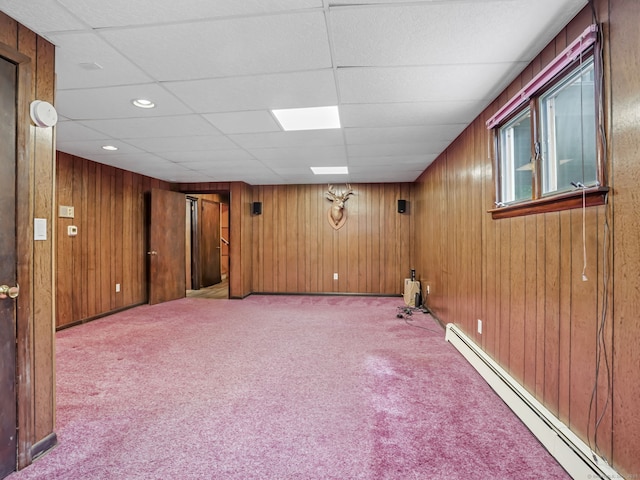 below grade area with a baseboard radiator, carpet floors, wood walls, and recessed lighting