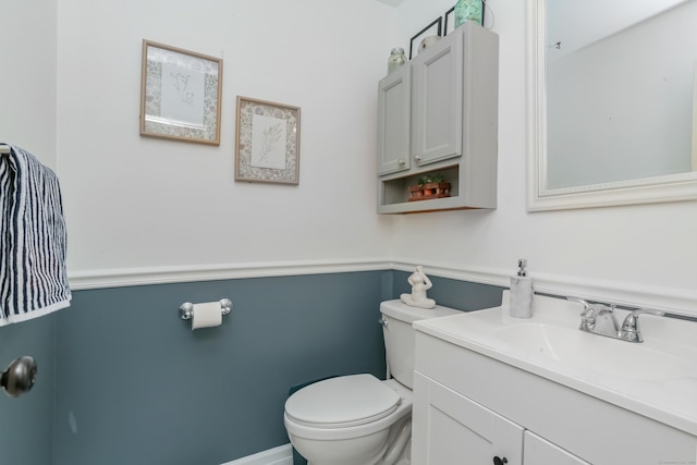 half bath featuring toilet and vanity