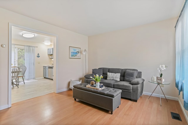 living room featuring light wood-style flooring and baseboards