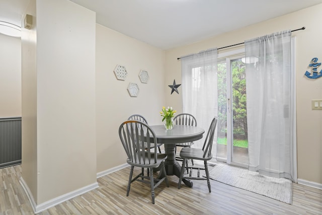dining room with light wood-style floors and baseboards