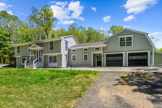 138 Flood Rd, Marlborough, CT 06447 - view of front of home featuring asphalt driveway, a front yard, a gambrel roof, and an attached garage