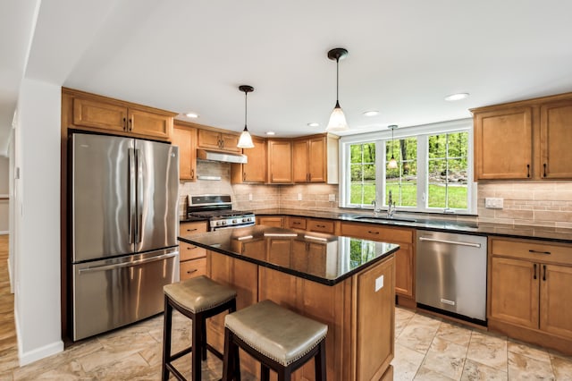 138 Flood Rd, Marlborough, CT 06447 - kitchen with stainless steel appliances, a sink, under cabinet range hood, brown cabinets, and recessed lighting
