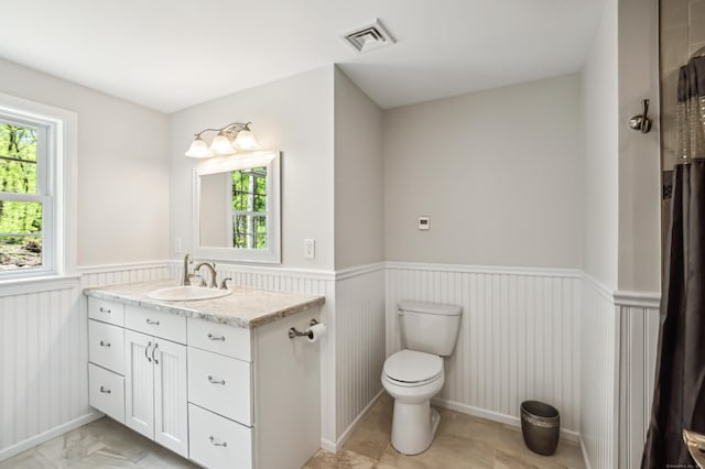 138 Flood Rd, Marlborough, CT 06447 - bathroom featuring wainscoting, healthy amount of natural light, toilet, and vanity