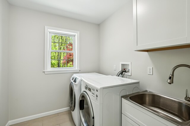 138 Flood Rd, Marlborough, CT 06447 - laundry room with cabinet space, washing machine and dryer, light tile patterned floors, and baseboards