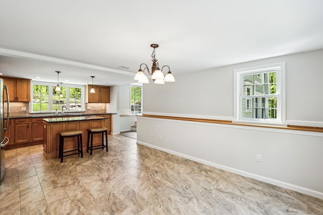 138 Flood Rd, Marlborough, CT 06447 - kitchen with a sink, plenty of natural light, a chandelier, and brown cabinetry
