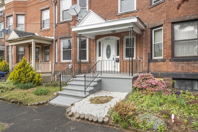 669 Third Ave, West Haven, CT 06516 - entrance to property featuring brick siding and covered porch