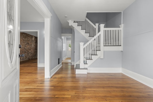 669 Third Ave, West Haven, CT 06516 - entrance foyer featuring hardwood / wood-style flooring, stairs, baseboards, and brick wall