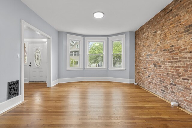 669 Third Ave, West Haven, CT 06516 - entrance foyer with brick wall, hardwood / wood-style flooring, and baseboards