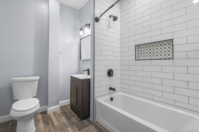 669 Third Ave, West Haven, CT 06516 - full bathroom with wood finished floors, toilet, vanity, washtub / shower combination, and baseboards
