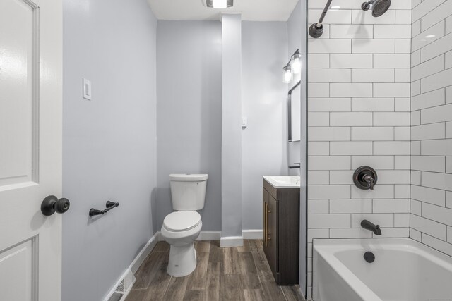 669 Third Ave, West Haven, CT 06516 - full bath with wood finished floors, vanity, toilet, bathing tub / shower combination, and baseboards
