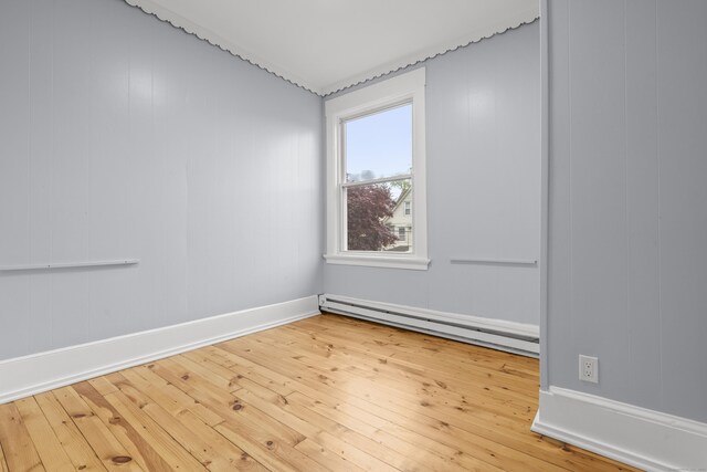 669 Third Ave, West Haven, CT 06516 - spare room with baseboard heating, hardwood / wood-style flooring, and baseboards