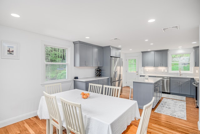 dining area featuring light wood-type flooring, recessed lighting, and baseboards
