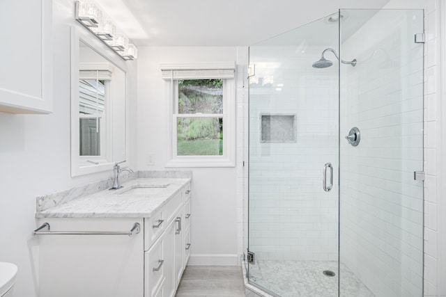 bathroom featuring a shower stall, vanity, toilet, and wood finished floors