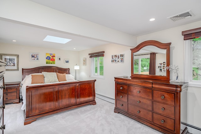 bedroom featuring a skylight, a baseboard heating unit, light colored carpet, and recessed lighting