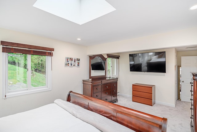 carpeted bedroom with baseboards, recessed lighting, and a skylight