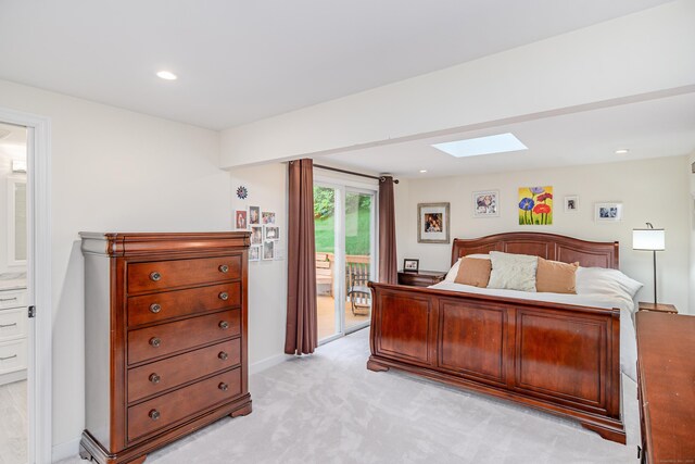 bedroom with a skylight, access to outside, light carpet, recessed lighting, and baseboards