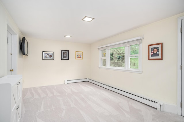 carpeted spare room with a baseboard radiator
