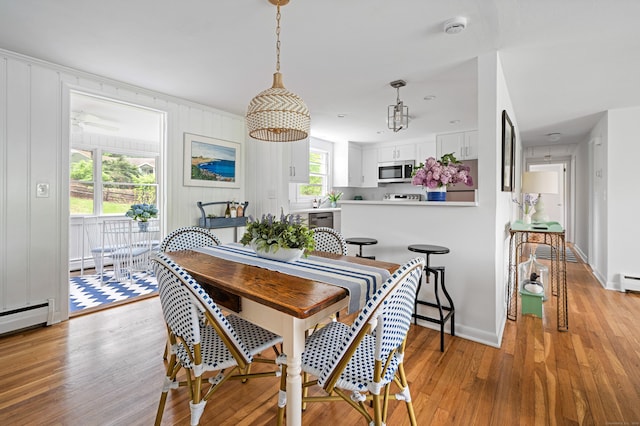 14 Arnold Ln, Norwalk, CT 06853 - dining room featuring light wood-type flooring, baseboards, and baseboard heating