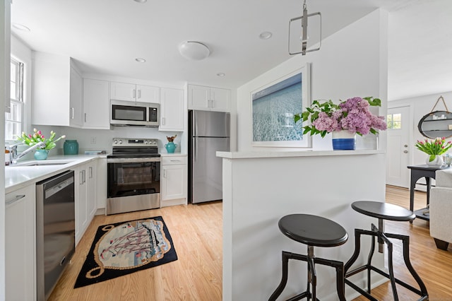 14 Arnold Ln, Norwalk, CT 06853 - kitchen featuring stainless steel appliances, a sink, light countertops, and light wood-type flooring