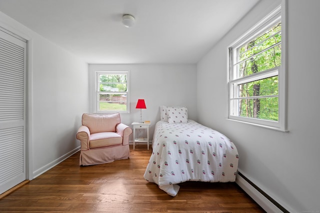 14 Arnold Ln, Norwalk, CT 06853 - bedroom featuring baseboard heating, wood finished floors, baseboards, and a closet