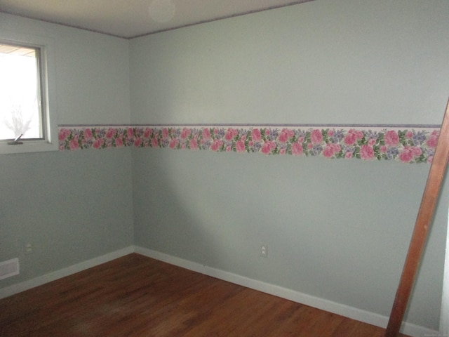 unfurnished room featuring dark wood finished floors and baseboards