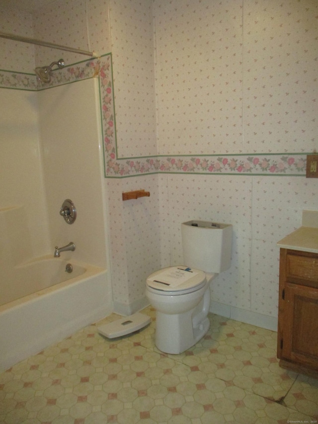 full bathroom featuring toilet, vanity, shower / washtub combination, baseboards, and tile patterned floors