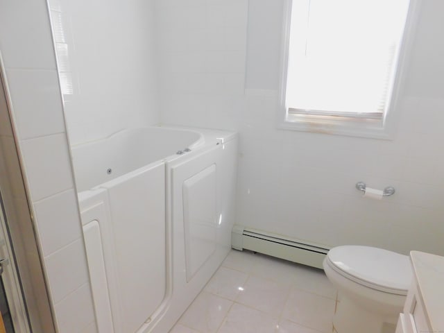 29 Barholm Ave, Stamford, CT 06907 - bathroom featuring baseboard heating, tile walls, a jetted tub, tile patterned floors, and vanity