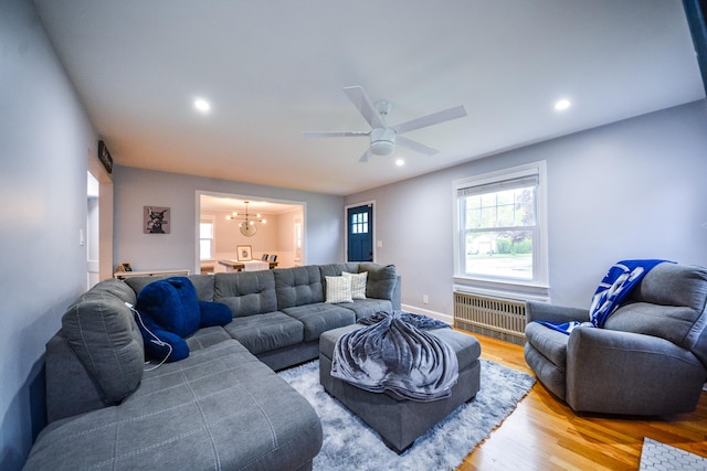 living room featuring radiator heating unit, a chandelier, wood finished floors, ceiling fan, and recessed lighting