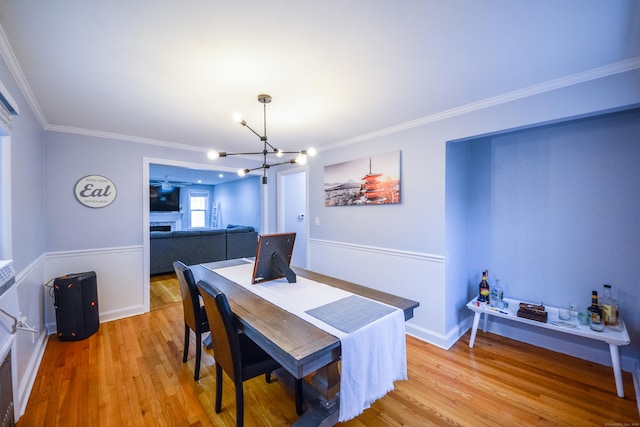 dining room featuring a chandelier, wood finished floors, and ornamental molding