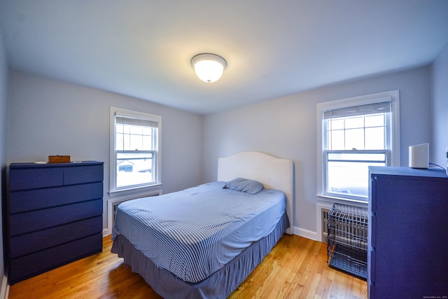 bedroom with wood finished floors and baseboards