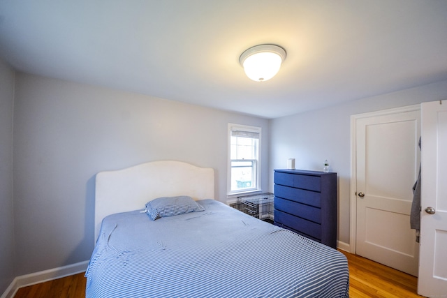 bedroom featuring light wood-style floors and baseboards