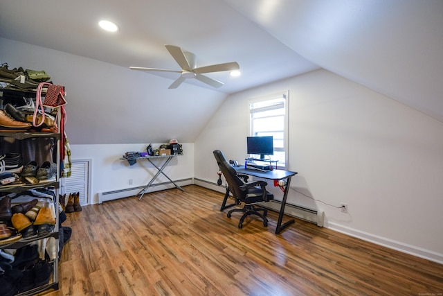 office space featuring a baseboard radiator, ceiling fan, wood finished floors, vaulted ceiling, and baseboards
