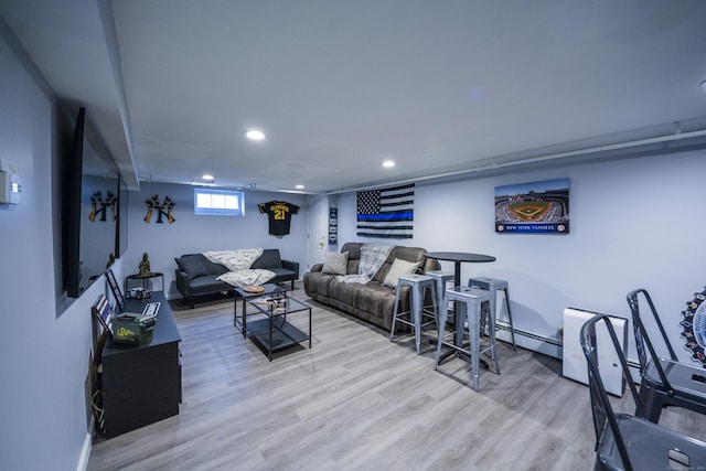 living room with wood finished floors, recessed lighting, and a baseboard radiator