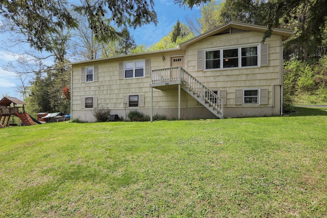 back of house featuring stairway and a lawn