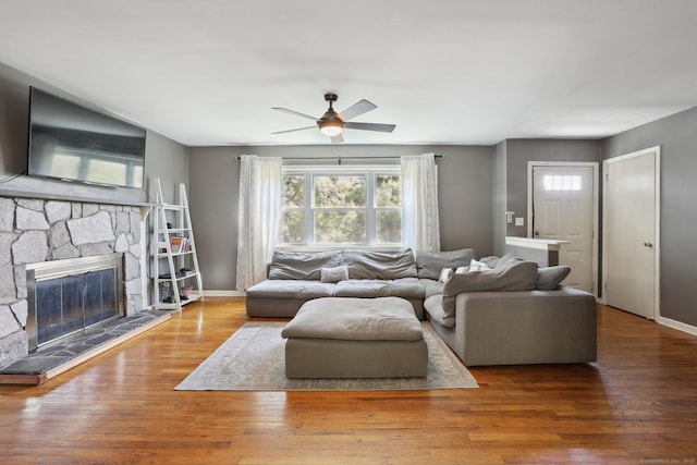 living room featuring plenty of natural light, ceiling fan, and wood finished floors
