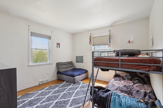 bedroom with wood finished floors and baseboards