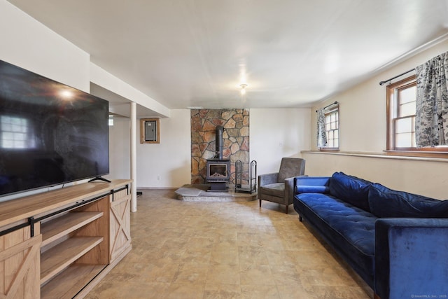 living room with a wood stove and electric panel