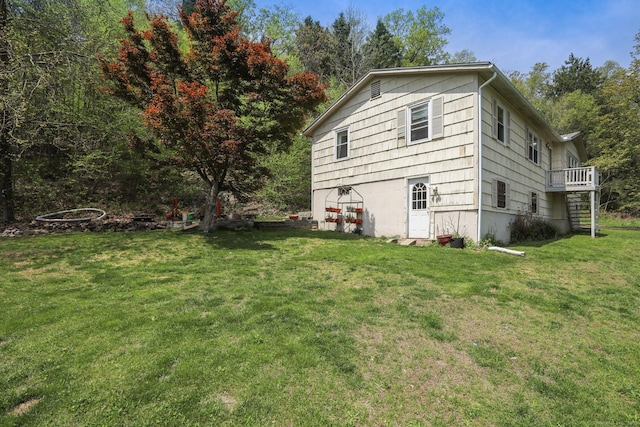 view of property exterior featuring a yard and a wooden deck