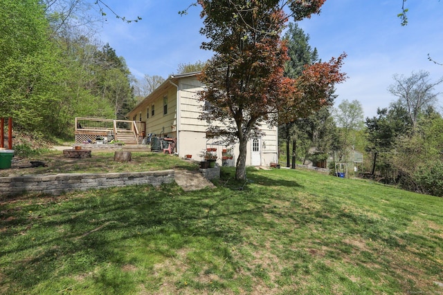 view of grassy yard featuring a wooden deck