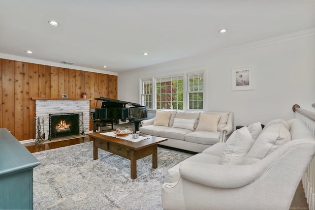 9 Cindy Ln, Norwalk, CT 06851 - living room featuring crown molding, recessed lighting, a brick fireplace, wooden walls, and wood finished floors