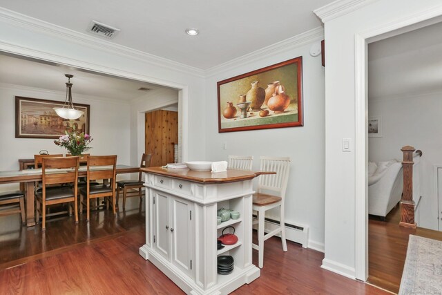 9 Cindy Ln, Norwalk, CT 06851 - dining space featuring a baseboard radiator, dark wood-style floors, ornamental molding, and baseboards