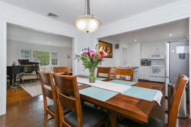 9 Cindy Ln, Norwalk, CT 06851 - dining area with dark wood-style floors, ornamental molding, and recessed lighting