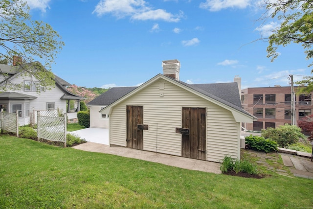 72 Locust Ave, New Canaan, CT 06840 - rear view of house featuring a patio and a shingled roof